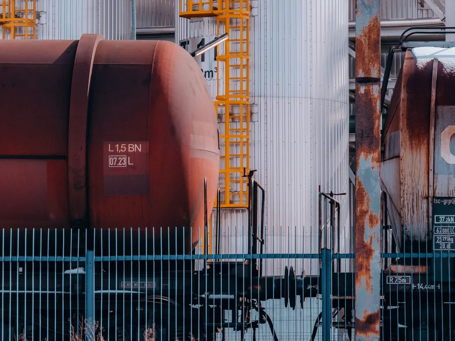 Rail tank wagons alongside bulk fuel storage tanks at a terminal